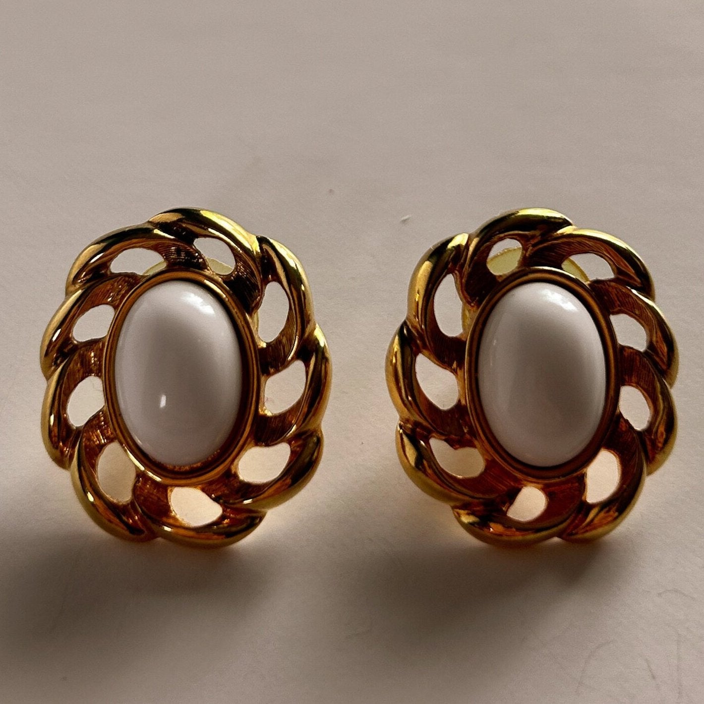 Vintage signed Monet gold and white earrings.